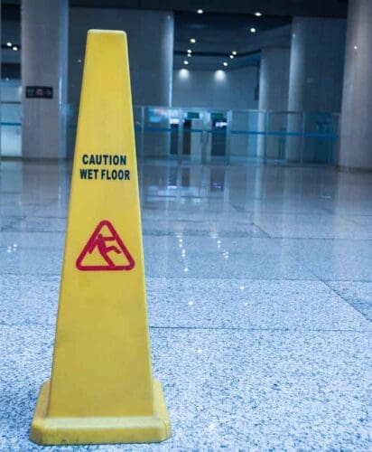 Wet floor sign on paving