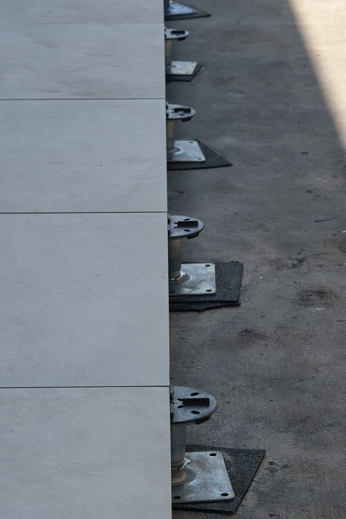 Paving on line of fixed head pedestals