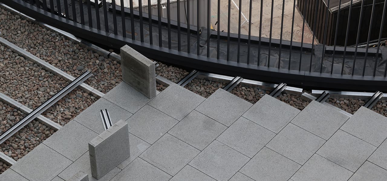 Paving rail system reaching balustrade