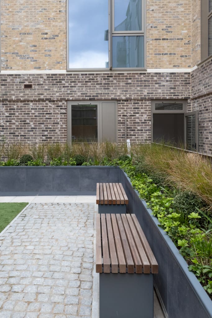 Eiger Porcelain Planters and benches around courtyard