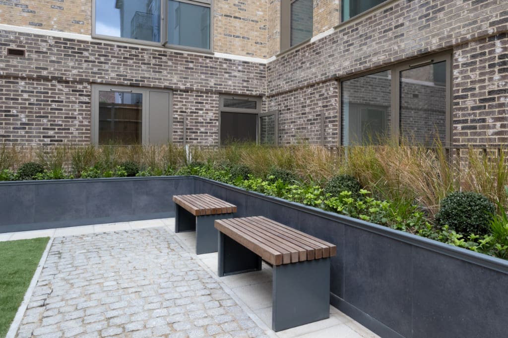 Eiger Porcelain Planters and benches around courtyard
