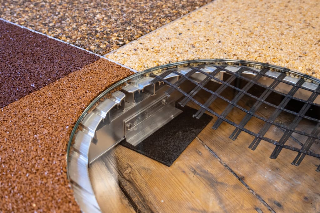 Resin Bound Gravel and Rubber Crumb on Baseboard rail system