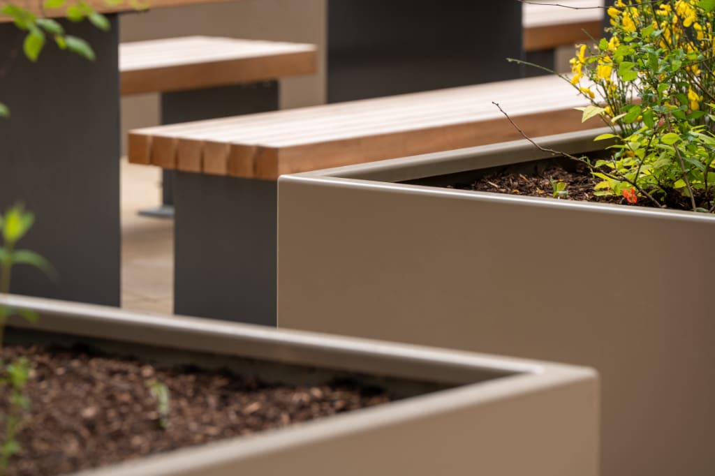 Planters with bench on paving