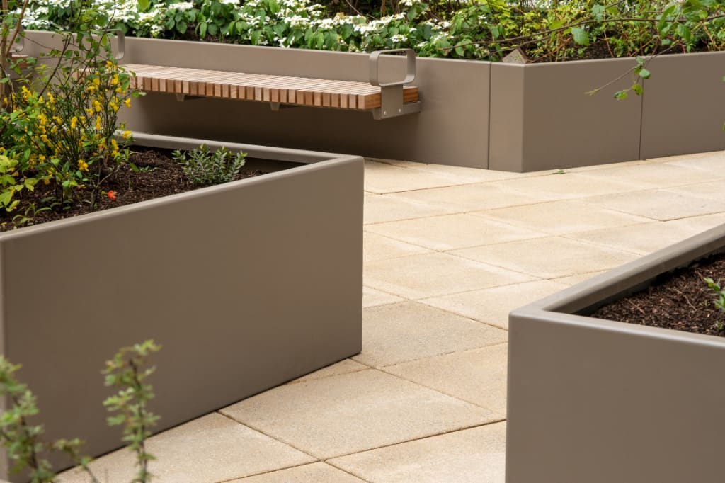 Planters with bench on paving