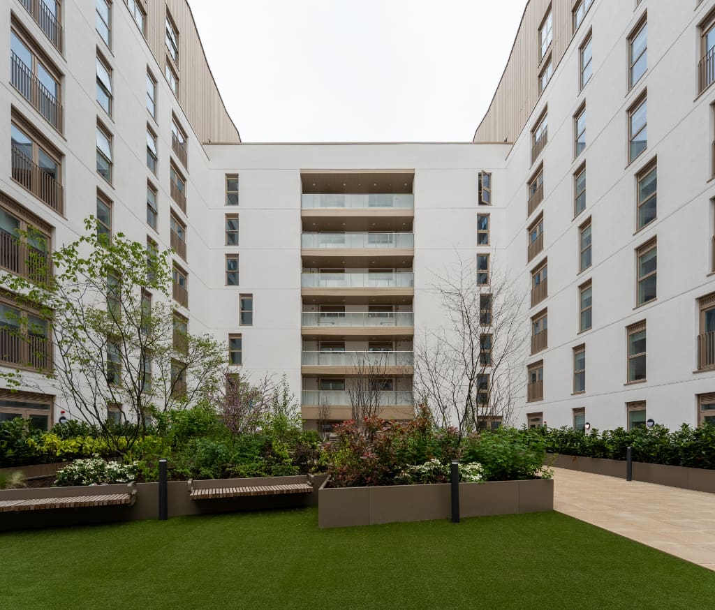 Planters with seating on artificial grass and paving