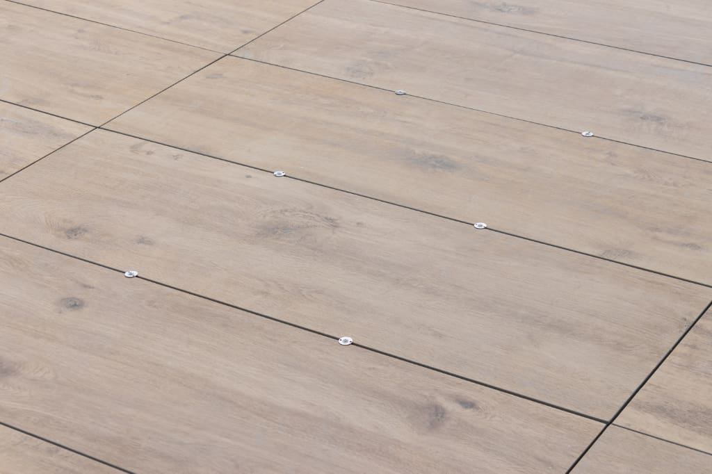 Cario Warm Sand porcelain paving with wind uplift clips