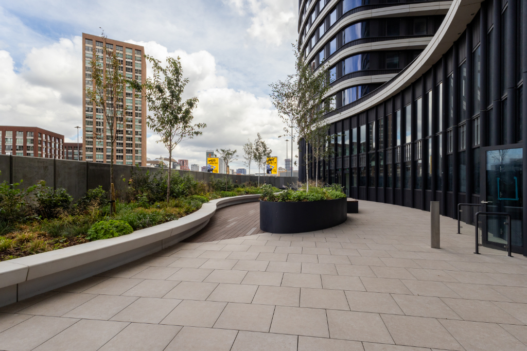 Courtyard with paving, vitrified composite decking, and planters