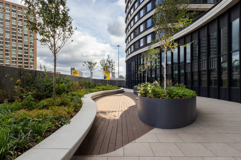Courtyard with paving, vitrified composite decking, and planters