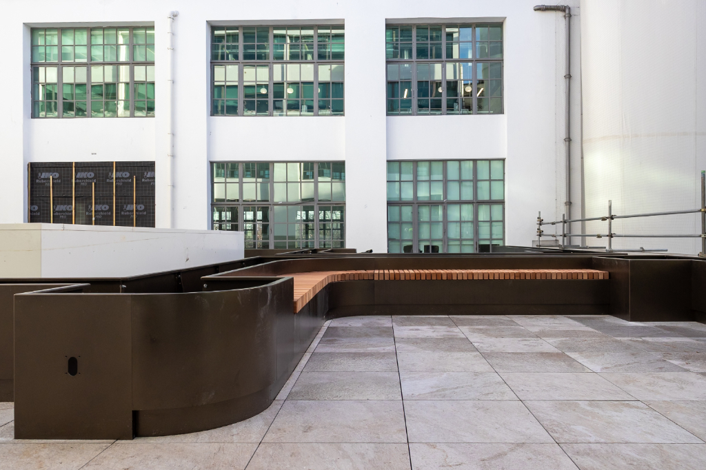 Planters under construction on rail paving system