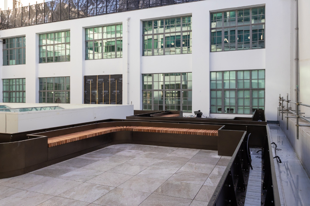 Planters under construction on rail paving system