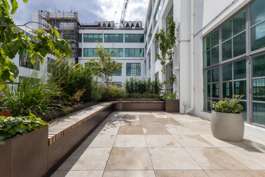 Paved roof terrace, seating, and planters