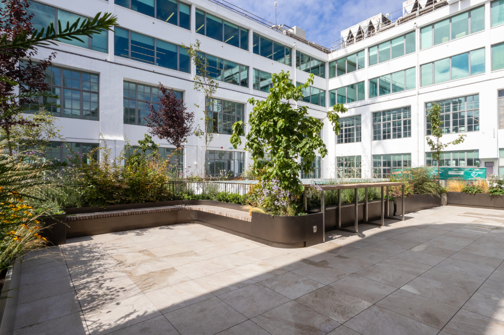 Paved roof terrace with planter and seating